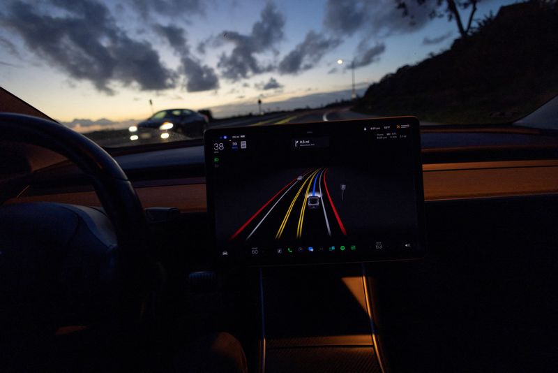 &copy; Reuters. FILE PHOTO: A Tesla Model 3 vehicle is shown using the Full Self Driving Beta software (FSD) while navigating a city road in Encinitas, California, U.S., February 28, 2023. REUTERS/Mike Blake/File Photo