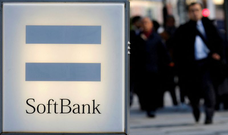 &copy; Reuters. FILE PHOTO: People walk behind the logo of SoftBank Corp in Tokyo December 18, 2014.  REUTERS/Toru Hanai/File Photo