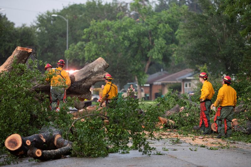 &copy; Reuters. FILE PHOTO: Houston Fire Department Wildland District 14 crews assess a downed tree blocking a street after a severe storm caused widespread damage in Spring Branch, Texas, U.S., May 17, 2024. REUTERS/Kaylee Greenlee Beal/File Photo