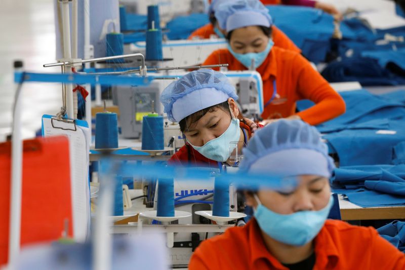 &copy; Reuters. Women work at Hung Viet garment export factory in Hung Yen province, Vietnam December 30, 2020. REUTERS/Kham/ File Photo