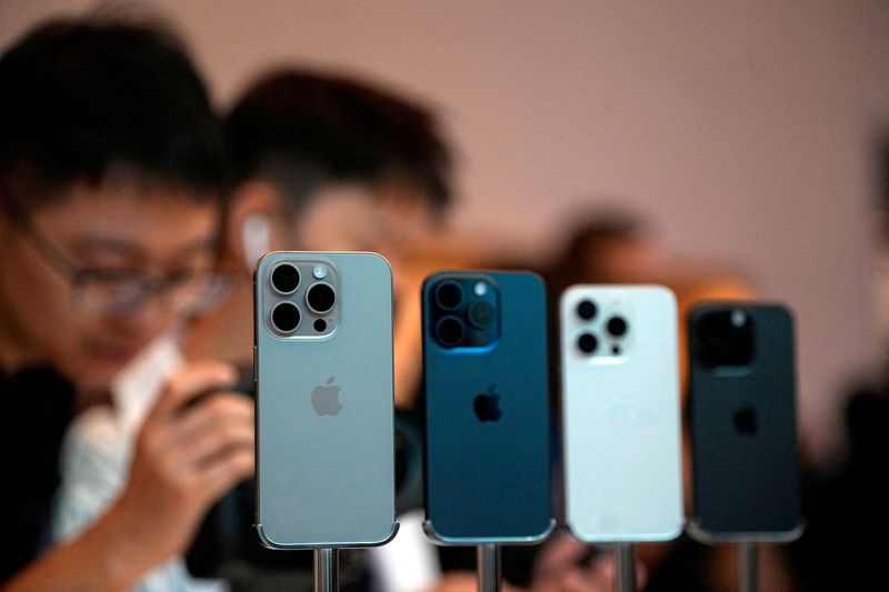© Reuters. FILE PHOTO: People look at the new iPhone 15 Pro as Apple's new iPhone 15 officially goes on sale across China at an Apple store in Shanghai, China September 22, 2023. REUTERS/Aly Song/File Photo