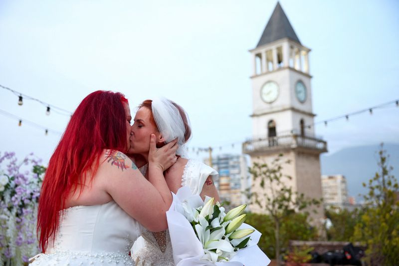 &copy; Reuters. Alba Ahmetaj and Edlira Mara kiss during their wedding ceremony at the rooftop of the Mayor's office, even though no law allows same-sex marriage, in Tirana, Albania, May 19, 2024. REUTERS/Florion Goga