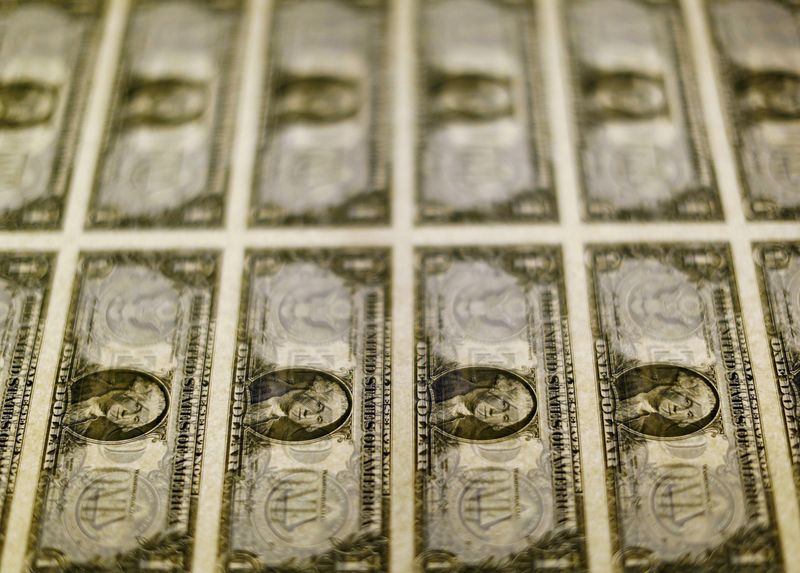 &copy; Reuters. FILE PHOTO: United States one dollar bills are seen on a light table at the Bureau of Engraving and Printing in Washington in this November 14, 2014. REUTERS/Gary Cameron/File Photo