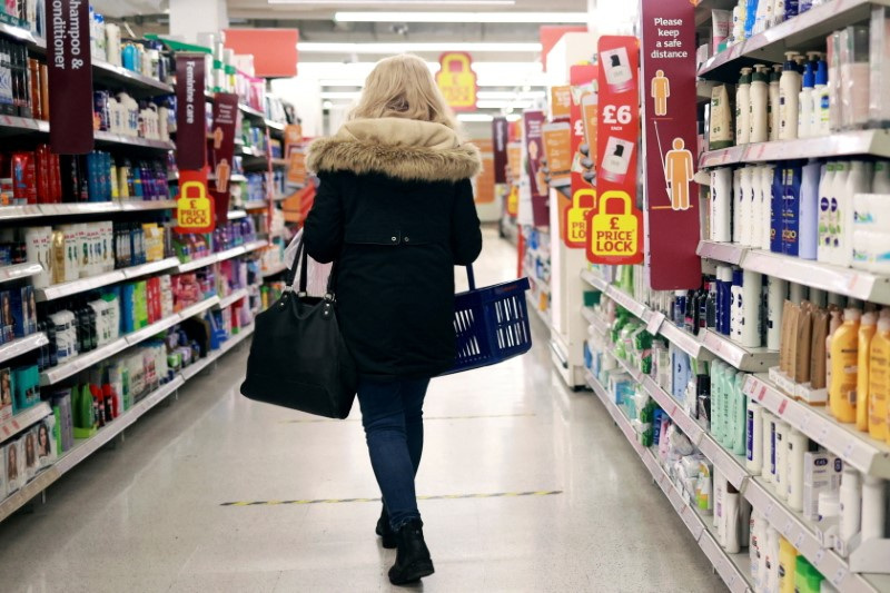 © Reuters. FILE PHOTO: A woman shops at a Sainsbury's supermarket, amid the spread of the coronavirus disease (COVID-19), in London, Britain January 11, 2021. REUTERS/Hannah McKay