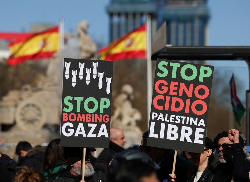 &copy; Reuters. FILE PHOTO: People hold anti-war placards during a protest to call for a ceasefire in Gaza to mark 100 days since the start of the conflict between Israel and the Palestinian Islamist group Hamas, in Madrid, Spain, January 20, 2024. REUTERS/Isabel Infante