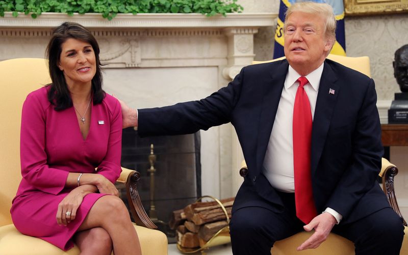 © Reuters. FILE PHOTO: U.S. President Donald Trump reaches out to outgoing U.S. Ambassador to the United Nations Nikki Haley as they meet in the Oval Office of the White House after the president accepted Haley's resignation in Washington, U.S., October 9, 2018. REUTERS/Jonathan Ernst/File Photo