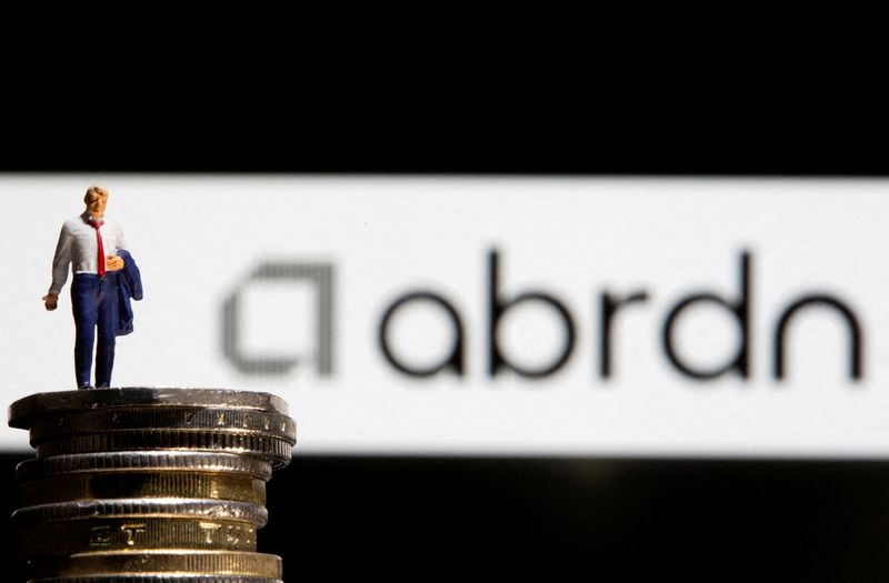 &copy; Reuters. FILE PHOTO: Businessman toy figure is placed on U.K. Pound coins in front of displayed Abrdn logo in this illustration taken, November 8, 2021. REUTERS/Dado Ruvic/Illustration