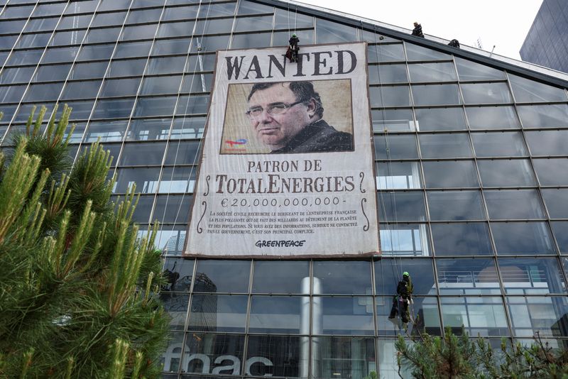 &copy; Reuters. Greenpeace activists deploy a banner with the portrait of French energy group TotalEnergies CEO Patrick Pouyanne saying 'WANTED: Boss of TotalEnergies, The civil society is looking for the CEO of the French company that is the most polluting, making billi
