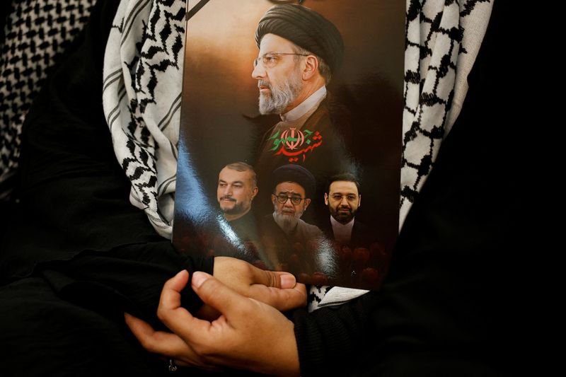 &copy; Reuters. FILE PHOTO: The pictures of the late Iranian President Ebrahim Raisi along with other officials who were killed in a helicopter crash, is held during a vigil to pay tribute to them at the Iranian Ambassador's residence in Jakarta, Indonesia, May 22, 2024.