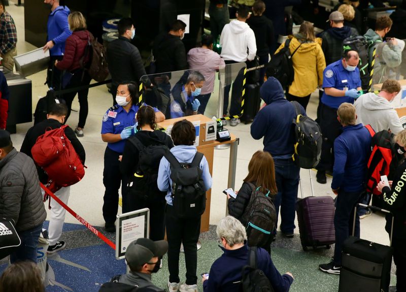 &copy; Reuters. FILE PHOTO: TSA workers check travellers identifications at a security checkpoint at Seattle-Tacoma International Airport before the Thanksgiving holiday in Seattle, Washington, U.S. November 24, 2021.  REUTERS/Lindsey Wasson/File Photo 