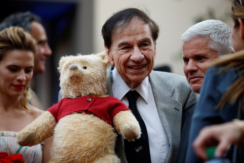 © Reuters. FILE PHOTO: Songwriter Richard M. Sherman holds a stuffed Winnie the Pooh as he poses at the world premiere of Disney's 