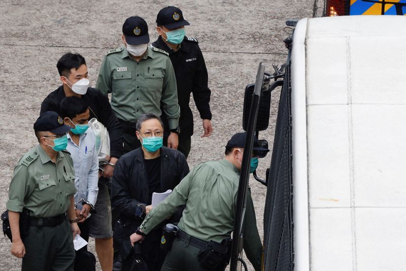 &copy; Reuters. FILE PHOTO: Pro-democracy activist Benny Tai walks to a prison van to head to court over the national security law charge, in the early morning, in Hong Kong, China March 2, 2021. REUTERS/Tyrone Siu/File Photo