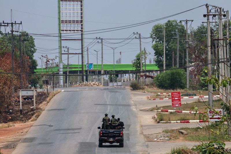 © Reuters. FILE PHOTO: Soldiers from the rebel Karen National Liberation Army (KNLA) patrol on a vehicle next to an area destroyed by the Myanmar military's airstrike in Myawaddy, the Thailand-Myanmar border town, April 15, 2024. REUTERS/Athit Perawongmetha//File Photo