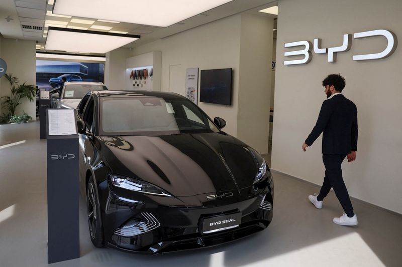 © Reuters. A person walks next to BYD Seal car in a BYD Auto company and Autotorino store in Milan, Italy, March 20, 2024. REUTERS/Claudia Greco/File Photo