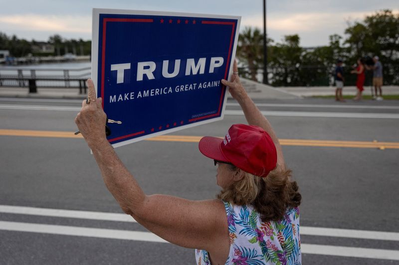 &copy; Reuters. FILE PHOTO: A supporter holds a placard following the announcement of the verdict in former U.S. President Donald Trump's criminal trial over charges that he falsified business records to conceal money paid to silence porn star Stormy Daniels in 2016, out