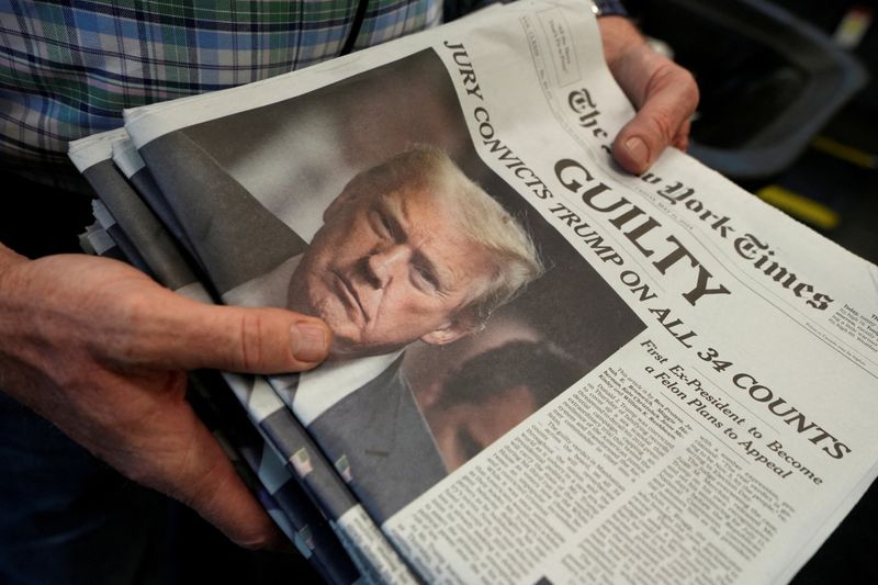 &copy; Reuters. A person holds New York Times newspapers, as they are being printed, following the announcement of the verdict on former U.S. President Donald Trump's criminal trial, over charges that he falsified business records to conceal money paid to silence adult f