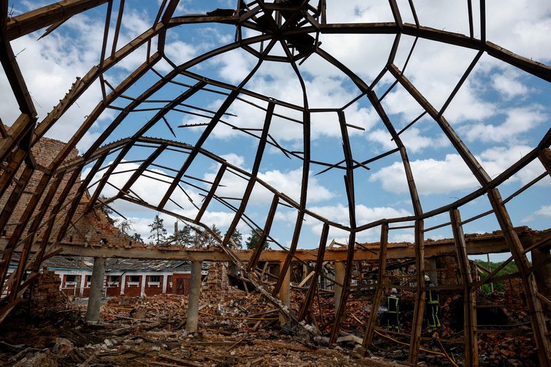 © Reuters. FILE PHOTO: Firefighters work at the site of the Kids and Youth Sport Riding School heavily damaged by Russian missile strikes, amid Russia's attack on Ukraine, in the village of Mala Danylivka, outside Kharkiv, Ukraine May 30, 2024. REUTERS/Valentyn Ogirenko/File Photo