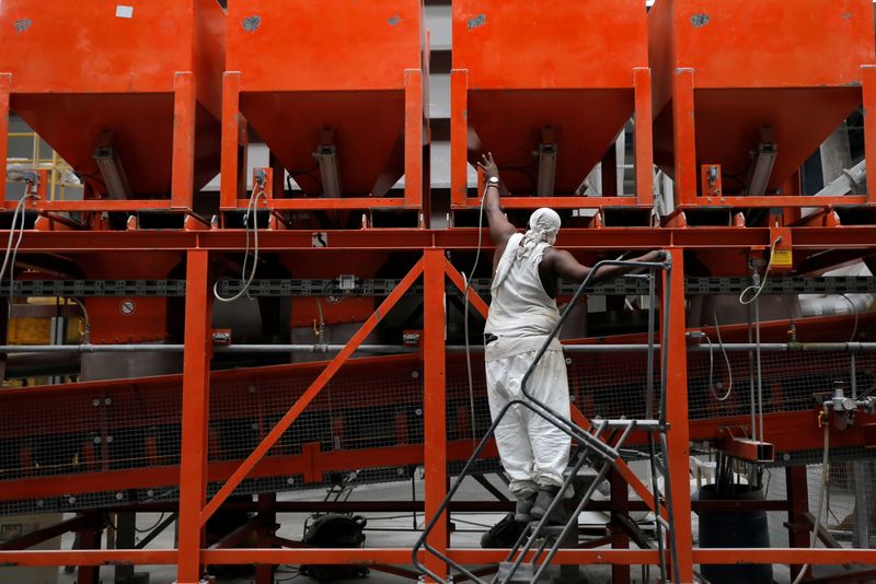 © Reuters. A worker checks equipment in the factory at IceStone, a manufacturer of recycled glass countertops and surfaces, in New York City, New York, U.S., June 3, 2021. REUTERS/Andrew Kelly