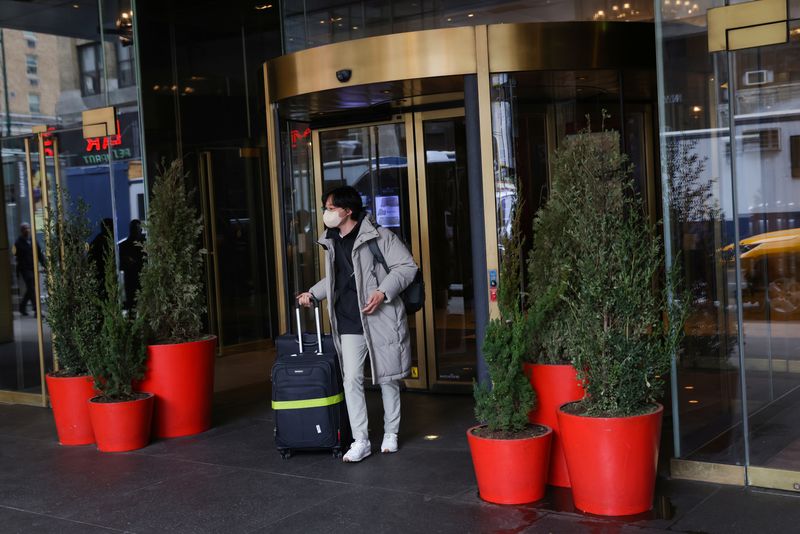 © Reuters. FILE PHOTO: A person exits an InterContinental hotel in Manhattan, New York City, U.S., March 23, 2022. REUTERS/Andrew Kelly/File Photo