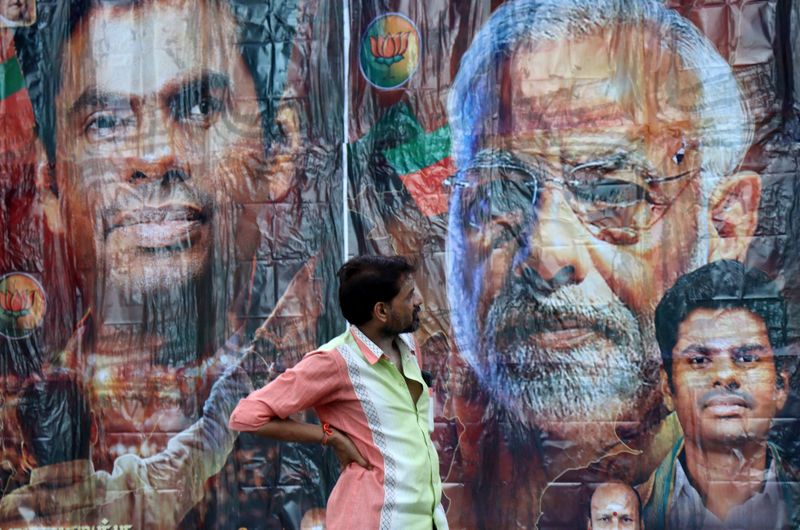 © Reuters. A man stands in front of a poster featuring India's Prime Minister Narendra Modi and Bharatiya Janata Party (BJP) election candidate K. Annamalai, outside its party office in Chennai, India, June 4, 2024. REUTERS/Riya Mariyam R