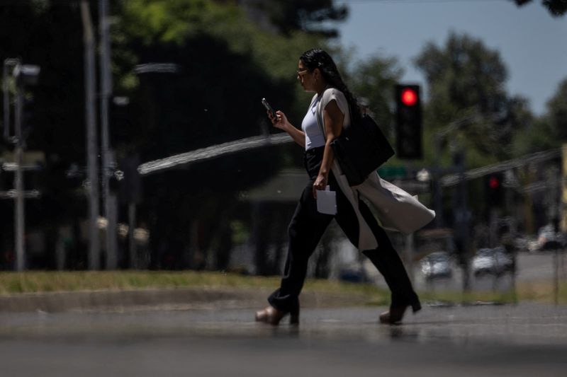 © Reuters. A person crosses an empty street as temperatures are expected to soar above 100 degrees Fahrenheit (37.8 degrees Celsius) during the summer's first heat, in Sacramento, California, U.S., June 4, 2024. REUTERS/Carlos Barria