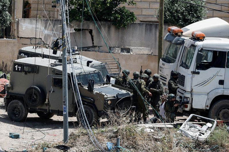 &copy; Reuters. Soldados israelenses detêm um palestino durante ataque israelense em Deir al-Ghusun, na Cisjordânia ocupada por Israeln04/05/2024nREUTERS/Raneen Sawafta
