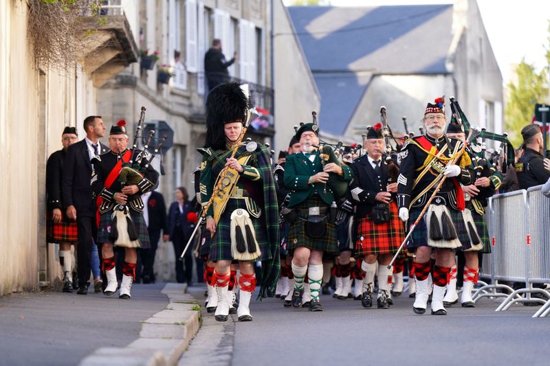 &copy; Reuters. International pipers from France, Germany and the United Kingdom during a procession from Bayeux Cathedral to the Great Vigil at the Commonwealth War Grave Commission's  Bayeux War Cemetery in Normandy, France, to commemorate the 80th anniversary of D-Day