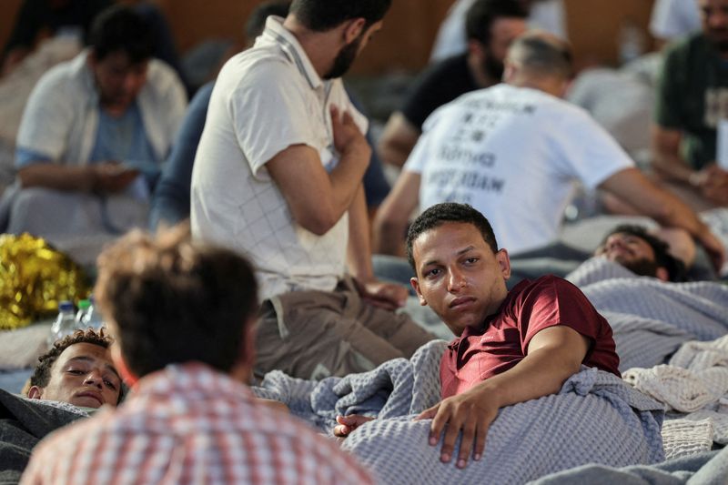 © Reuters. FILE PHOTO: Egyptian survivor Mahmoud Shalabi, 22, one of the 104 survivors of a deadly migrant shipwreck off southwestern Greece, rests in a shelter following a rescue operation, in Kalamata, Greece, June 14, 2023. REUTERS/Stelios Misinas/File Photo