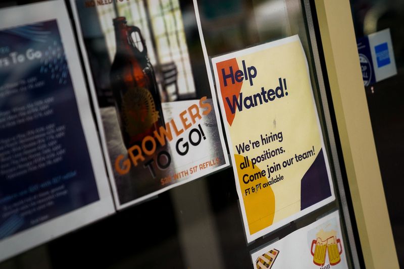 © Reuters. FILE PHOTO: An employee hiring sign is seen in a window of a business in Arlington, Virginia, U.S., April 7, 2023. REUTERS/Elizabeth Frantz/file photo