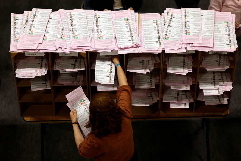 © Reuters. An electoral worker pigeon holes local election ballot papers after counting at a local election counting centre, in Dublin, Ireland, June 8, 2024. REUTERS/Clodagh Kilcoyne