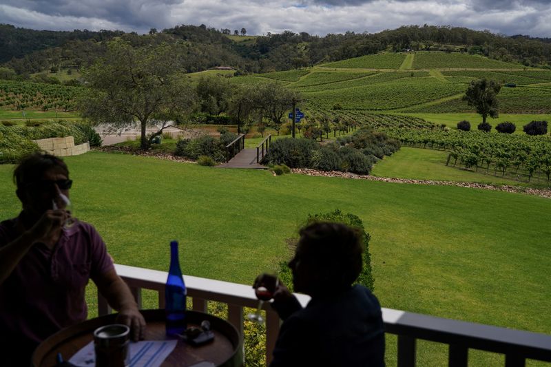 &copy; Reuters. FILE PHOTO: Patrons enjoy outdoor wine tasting against the backdrop of the vineyard at Ivanhoe Wines, as wineries in the Hunter Valley region in the state of New South Wales, in Pokolbin, Australia, November 14, 2021. Picture taken November 14, 2021.  REU