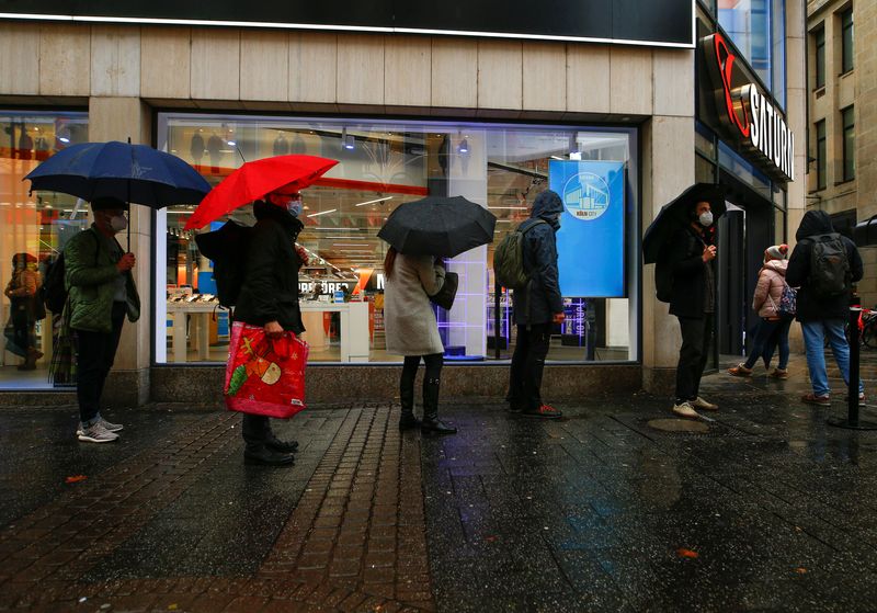 &copy; Reuters. FILE PHOTO: Shoppers queue in front of a shop in Cologne, Germany, December 15, 2020. REUTERS/Thilo Schmuelgen/File Photo