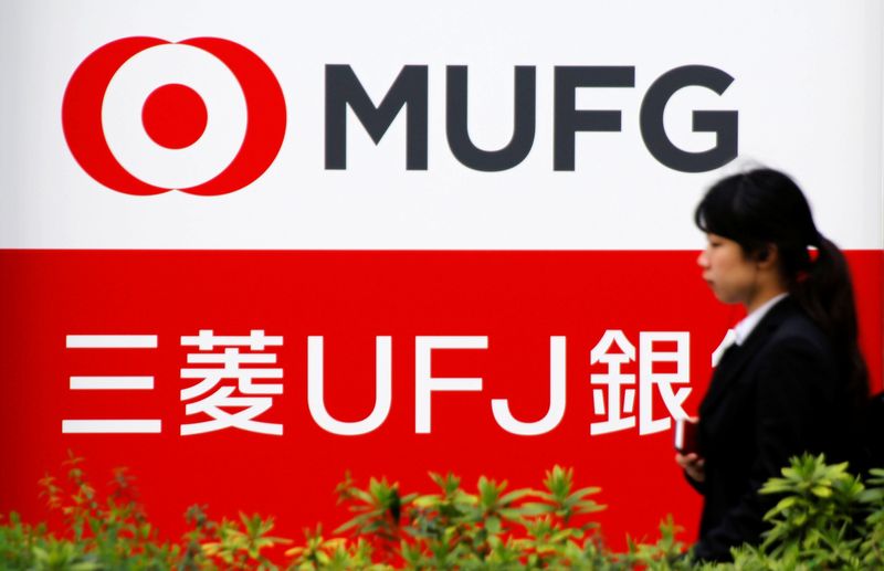 &copy; Reuters. FILE PHOTO: A woman walks past a signboard of MUFG Bank in Tokyo, Japan April 3, 2018. REUTERS/Toru Hanai