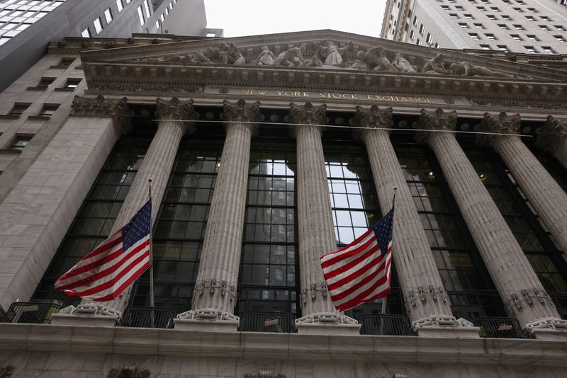 &copy; Reuters. FILE PHOTO: Flags are seen outside the New York Stock Exchange (NYSE) in New York City, where markets roiled after Russia continues to attack Ukraine, in New York, U.S., February 24, 2022.   REUTERS/Caitlin Ochs/File Photo