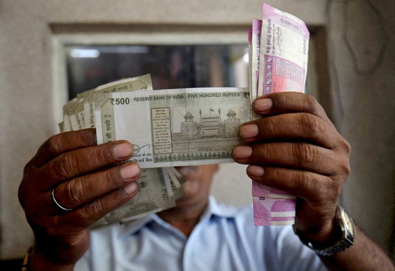 &copy; Reuters. FILE PHOTO: A cashier checks Indian rupee notes inside a room at a fuel station in Ahmedabad, India, September 20, 2018. REUTERS/Amit Dave/File Photo