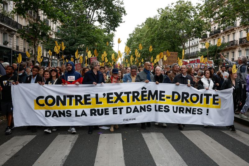 © Reuters. People hold a banner that reads 