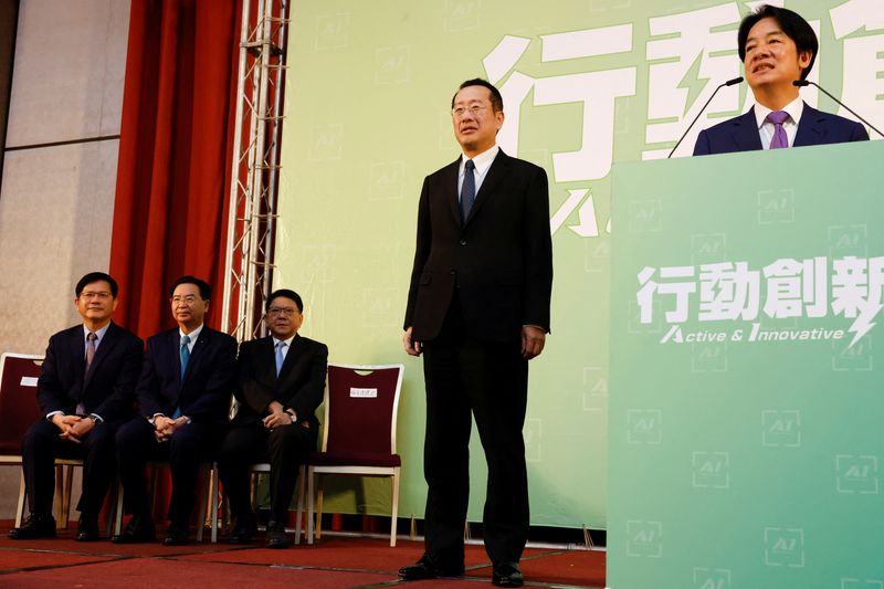 © Reuters. FILE PHOTO: Incoming Defence Minister Wellington Koo stands next to Taiwan President-elect Lai Ching-te while he speaks during a press conference where incoming cabinet members are announced, in Taipei, Taiwan April 25, 2024. REUTERS/Carlos Garcia Rawlins/File Photo