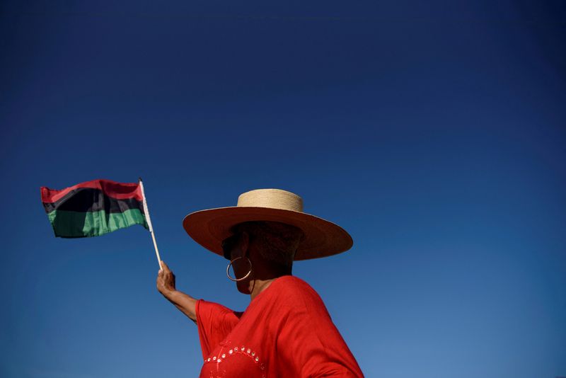 &copy; Reuters. FILE PHOTO: A person waves a flag during an emancipation march as people gather to celebrate Juneteenth, which commemorates the end of slavery in Texas, two years after the 1863 Emancipation Proclamation freed slaves elsewhere in the United States, in Gal