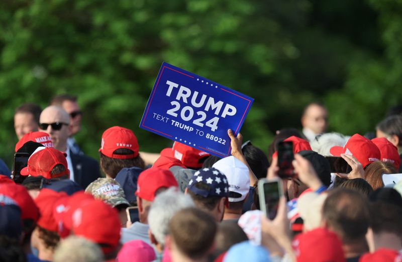 © Reuters. A person holds up a sign at a campaign rally by former U.S. President and Republican presidential candidate Donald Trump at Crotona Park in the Bronx borough of New York City, U.S., May 23, 2024.  REUTERS/Brendan McDermid/File Photo