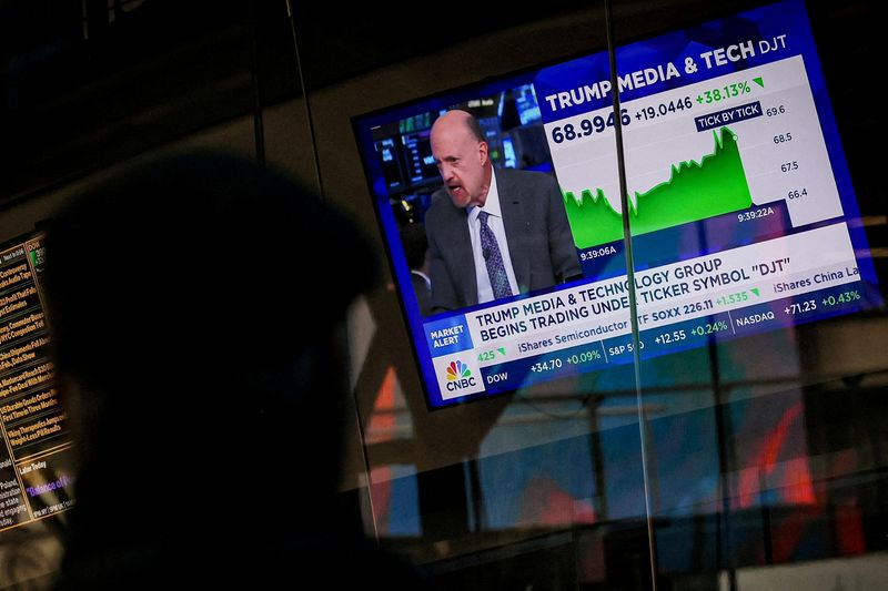 © Reuters. FILE PHOTO: A man looks at a screen that displays trading information about shares of Truth Social and Trump Media & Technology Group, outside the Nasdaq Market site in New York City, U.S., March 26, 2024.  REUTERS/Brendan McDermid/File Photo