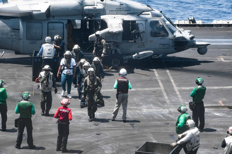 © Reuters. FILE PHOTO: Sailors from the Dwight D. Eisenhower Carrier Strike Group assist distressed mariners rescued from the Liberian-flagged, Greek-owned bulk carrier M/V Tutor that was attacked by Houthis, in the Red Sea, June 15, 2024.  U.S. Naval Forces Central Command/U.S. 5th Fleet/Handout via REUTERS/File Photo