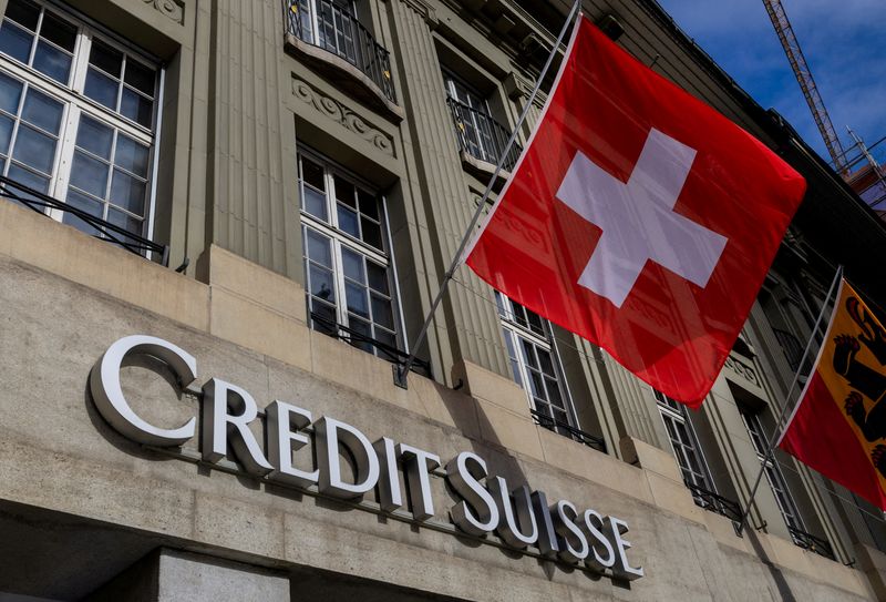 &copy; Reuters. FILE PHOTO: A Swiss flag is pictured above a logo of Swiss bank Credit Suisse in Bern, Switzerland, November 15, 2023.  REUTERS/Denis Balibouse/File Photo