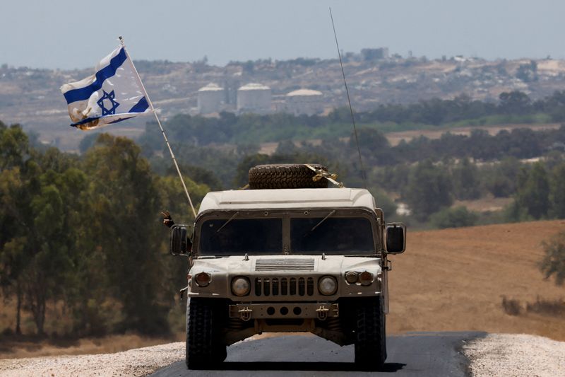 &copy; Reuters. FILE PHOTO: A military vehicle maneuvers near the Israel-Gaza border, amid the Israel-Hamas conflict, as seen from Israel, June 20, 2024. REUTERS/Amir Cohen/File Photo