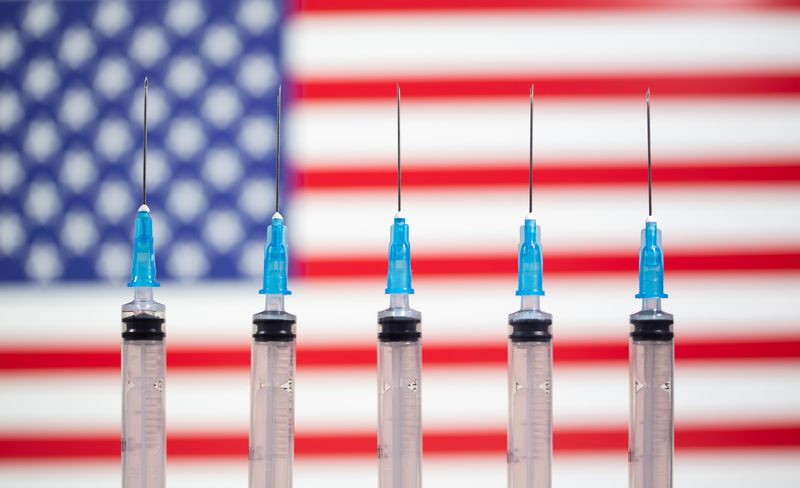 &copy; Reuters. Syringes are seen in front of a displayed U.S. flag in this illustration taken November 10, 2020. REUTERS/Dado Ruvic/Illustration/File Photo