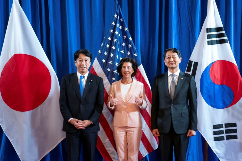 &copy; Reuters. Japan’s Economy, Trade and Industry Minister Ken Saito, U.S. Commerce Secretary Gina Raimondo and South Korea’s Minister of Trade, Industry and Energy Ahn Duk-geun pose for a press photo during the inaugural Trilateral Commerce and Industry Ministeria