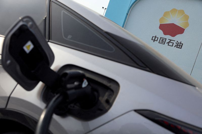 &copy; Reuters. FILE PHOTO: The PetroChina logo is seen near a car charging at the Chinese state oil giant's electric vehicle (EV) charging station in Beijing, China February 2, 2024. REUTERS/Florence Lo/File Photo