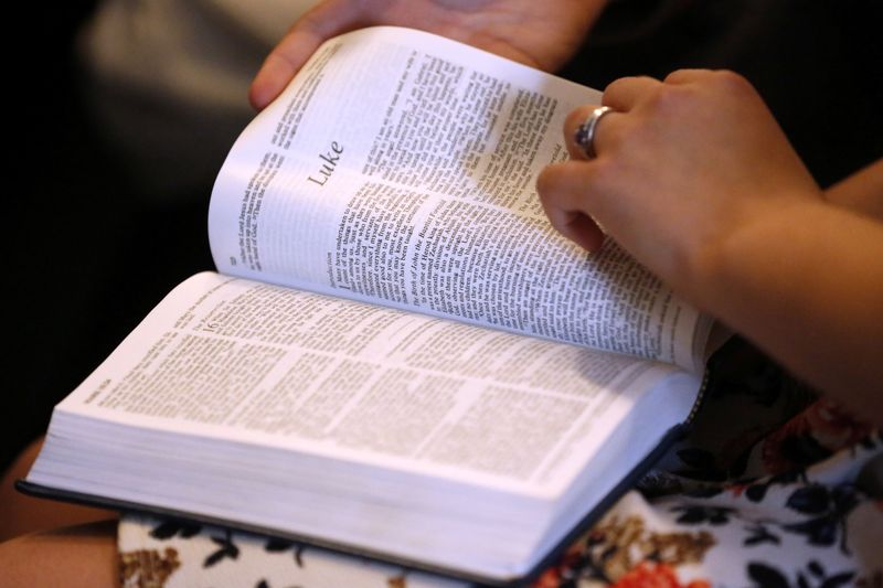 &copy; Reuters. Members of the community read from the Bible during a prayer service at the Arcadia First Baptist Church in Santa Fe, Texas, U.S., May 20, 2018. REUTERS/Jonathan Bachman/File photo