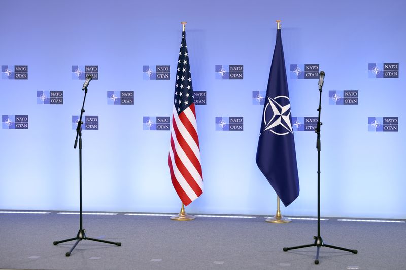 © Reuters. NATO and U.S. flags are seen before a news conference at NATO's headquarters in Brussels, Belgium April 14, 2021. Kenzo Tribouillard/Pool via REUTERS/File Photo