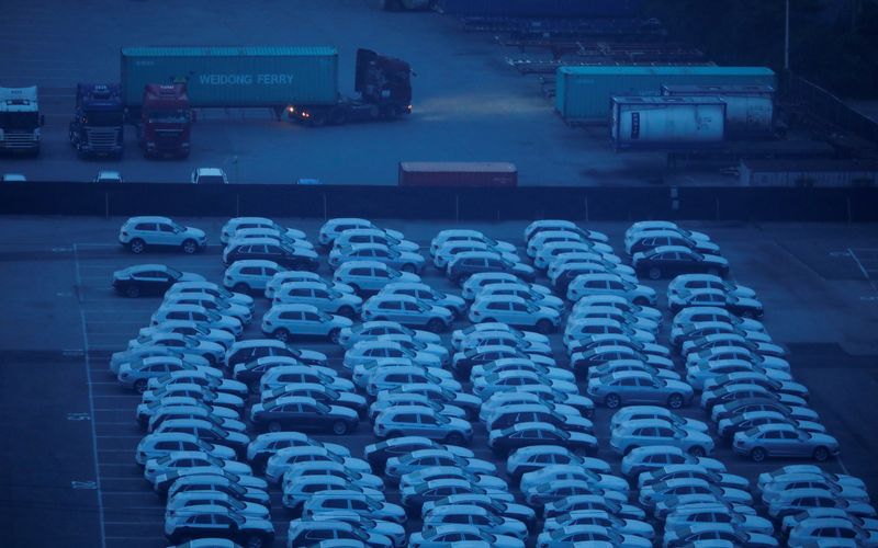 © Reuters. File photo: A truck transporting a shipping container drives past imported vehicles at Pyeongtaek port in Pyeongtaek, South Korea, July 9, 2020.    REUTERS/Kim Hong-Ji/File photo