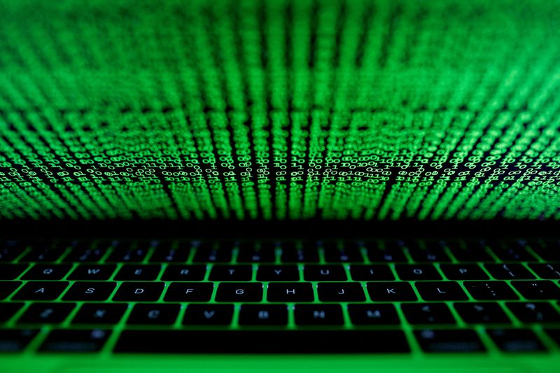 &copy; Reuters. FILE PHOTO: A computer keyboard lit by a displayed cyber code is seen in this illustration picture taken on March 1,  2017. REUTERS/Kacper Pempel/Illustration/File Photo